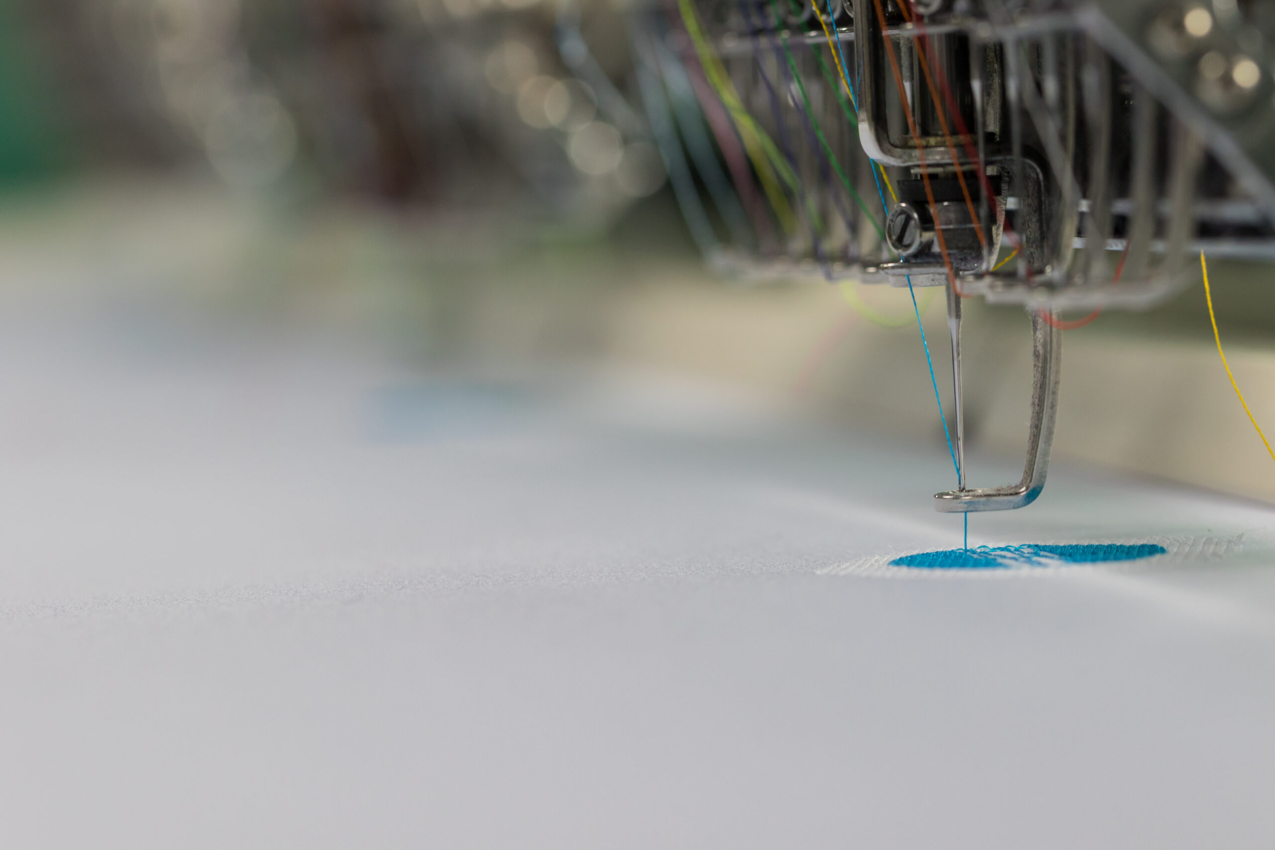 Embroidery machine needle stitching textile
